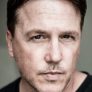 Lochlyn Munro is Larry Fitzgibbon